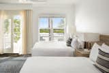 Porches on some of the rooms at Parrot Key Hotel and Villas lead off to sand, hammocks, and a view of the water.