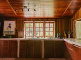 The couple also replaced the stove and extended the counters and cabinetry with an L-shaped layout. The windows provide views of the vegetation that surrounds the home. Jennifer says she spends a lot of time in the kitchen, even when she’s not cooking. “We view everything through the lens of food,” says Kenard.