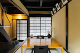 In the tatami room, a black wood zaisu, or legless chair, sits at either end of a vintage coffee table by Saburo Inui for Tendo Mokko. “At some point it was lacquered yellow by a previous owner,” says Whitney, who sourced the home’s furnishings.