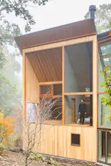 Mitsui stands in the guest room, which opens to a small balcony.