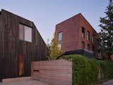 Clad in brick shingles to blend in with the neighborhood, the three-story building holds four condos, one of which the couple call home.