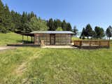 The property comes with multiple structures, including a greenhouse, main house, gardening shed, barn, guesthouse, and cabin.