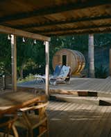 The deck includes both a barrel sauna and an outdoor shower.
