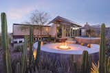 The outdoor gathering space has been expanded with a circular pool and firepit area.