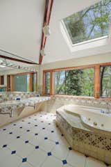 Skylights illuminate a charming tiled bathroom on the upper level..
