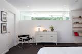 An interior clerestory window brings sunlight into this upper-level bedroom.