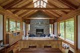 In the double-height living space, Marvin windows stretch nearly floor to ceiling, capturing light even on rainy days and offering panoramic views across the forest. The Douglas fir frame remains exposed throughout, adding warmth, continuity, and rhythm.