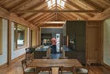 "One of the most important aspects of this house is the timber roof," says architect Gabe Hodge. "There are no interior partitions that engage with that roof—it’s free from the fireplace all the way to the other end of the house." The effect is a continuous, unbroken canopy that amplifies the feeling of openness. The kitchen, pantry, and powder room are conceived as a block of smaller spaces within the open floor plan.