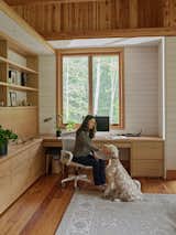 In Jenn’s office, tucked beside the stair hall, the walls stop short of the ceiling, allowing the timber roof to remain uninterrupted above. "We talked a lot about how she wanted the space to feel," says architect Gabe Hodge. "She placed a lot of value on how beautiful this roof was going to be." The resulting design preserves acoustic and visual connection to the rest of the home, with small interior apertures that keep the space visually tethered to the landscape and the wider home.
