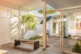 True to Eichler’s design ethos, the home has a central atrium planted with trees and shrubs.
