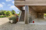 An elevator provides access from the open garage to both upper levels.