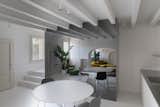 A mirrored storage unit reflects light throughout the lower-level kitchen