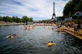 Swimmers in the water, at the Grenelle safe bathing site on the Seine river on its opening day, in front of the Eiffel Tower in Paris on July 5, 2025. The River Seine reopened to Parisian swimmers this morning for the first time since 1923, offering locals and tourists a welcome respite after scorching temperatures.