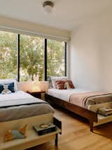 In the kids’ bedroom, a new lightwell gathers light from the building’s northwest corner. A restrained color palette throughout with soft white walls, ceilings, and kitchen cabinetry helps celebrate the natural light, while light oak floors, walnut casework, and slat walls emphasize a sense of warmth.&nbsp;