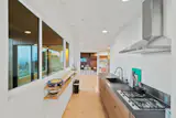 The kitchen sits at the center of the home, joining the private and common areas.