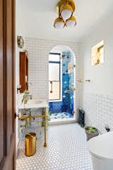 The renovated bathroom now features fixtures from Waterworks, Watermark Designs, and Kohler Veil.