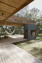 Most homes in the area have woodburning <i>parrillas</i> to make <i>asados</i>, or barbecues. Ochoa designed his own to be open on both sides, which provides extra heat to the patio during colder days. The deck is made of lapacho, and the ceilings are covered in straw. “It has a Japanese style, and also a beachy style,” says Ochoa.