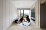 Architect Patrick Lam outfitted a 484-square-foot apartment with operable floor panels that lift up to store luggage.