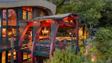 &nbsp;The current owners added a terrace with a large stone fireplace, hot tub, and serving bar.