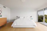 Two bedrooms occupy the lower floor, while the common areas are located on the top floor.