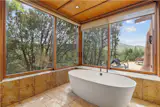 Oversized windows, skylights, and clerestory windows help bring in views of the surrounding landscape.
