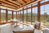 The floor-to-ceiling windows in the sunroom frame views of Atalaya Mountain.