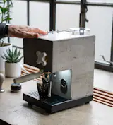 Three switches atop the unit provide streamlined functionality: one to pour hot water (handy for topping up an Americano or cleaning the portafilter), another to pull an espresso shot, and a third to turn on the steaming wand.