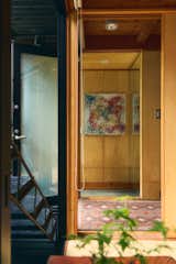 The three-story structure has a pair of external staircases set between the floor-to-ceiling windows and the shutters. A Chinese lacquer chest sits at the center of the ground-floor tatami room, which is used as a tearoom, a yoga space, and a guest room. Untitled 20-10, by Julia Ritson, an Australian artist from George’s hometown, hangs in the entryway. “Her kaleidoscopic painting prepares you for the world outside,” says George.