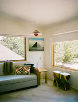 The office is furnished with a Louis Poulsen pendant and side tables the previous residents left behind.