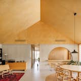 Architect João Completo used a limited material palette in the house he designed for his parents, a choice he appreciates in many homes featured in Dwell. Birch plywood and concrete are featured throughout. “The language is very coherent in every space, which gives it a sense of fluidity,” Completo says. “It feels a bit bigger than it is because the materials are the same everywhere.”