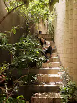 The second-floor space is reached via an external set of brick-and-concrete steps.