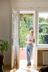 Designer Sarolta Hüttl stands in the living area of the 1930s apartment she revamped for her family in Budapest, Hungary.