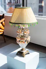 The lamp was inspired by linguine alle vongole, but with a Hollywood Regency twist. McCauley had the vintage lamp rewired and incorporated elements of the dish into the piece itself, from the pasta stripes on the shade to the literal clamshells that adorn the base.
