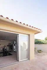 The converted garage is currently set up as a workshop and storage area.