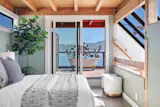 The lofted bedroom has a private deck, and it’s open to the living area below.