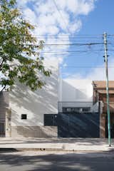 Architects Carlos Cottet and Victoria Iachetti of Cottet Iachetti transformed an old house in the quiet Agronomía neighborhood of Buenos Aires into a modern white-walled residence with straight lines and carefully placed windows.