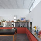 The heart of the home is a spacious kitchen, built under the existing bovedilla ceiling, a method of construction that was popular in the region in the early 20th century, with rows of shallow brick walls set between exposed steel beams.