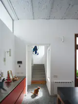 A view of the staircase leading up to the second floor, where the architects built a home office for Julián Romera, an art director, as well as a primary suite and a bedroom for the couple’s son, Félix.