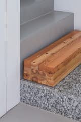 The kitchen’s wood-framed glass doors are original to the house, and the wood used to build the island was taken from old ceiling beams. One section of the island is topped with counter-height granite.