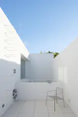 A second-floor terrace outside the primary suite. “The house reflects the DNA of the neighborhood,” says Analía. “From every room you see greenery or sky, something that’s rare in the city these days.”