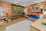 Separated from the common areas, the bedrooms are lined up along a hallway.