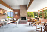 A wood-burning fireplace provides additional heat to the living room.