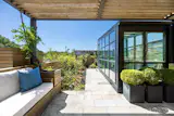 Up the glass-enclosed staircase is the rooftop deck, with views of the Manhattan skyline.