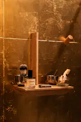 The leaf has held up for at least six months, says Shkurti, and the only thing that's really changed the surface is some splatter from water (it is a bathroom, after all), creating an effect similar to an antique mirror.