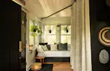The enclosed front porch now serves as a guest room with a daybed.