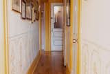 The low mural in interior designer Sydney Moss’s Brooklyn hallway helps split up the narrow space.