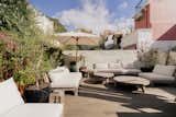 This revamped two-bedroom flat has warm, minimalist interiors and a 753-square-foot terrace for soaking up Lisbon’s sunny weather.
