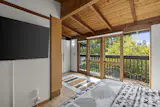 The upstairs bedroom opens to a private balcony.