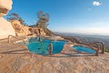 A waterfall and grotto are positioned poolside.