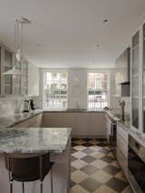 The kitchen and bathrooms were full gut renovations; updating the penthouse required hiding the HVAC, electrical systems, and plumbing behind existing woodwork and re-creating damaged paneling, plus installing new doors and windows, in the historic style.